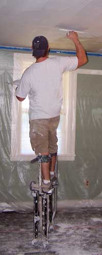 Troweling plaster during resurfacing a ceiling.  Avalanche Plastering